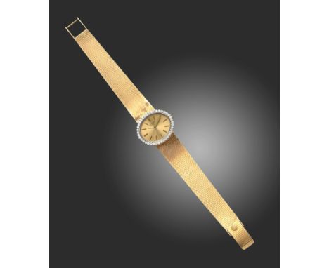 A lady's 18ct gold and diamond wristwatch by Patek Philippe, the signed oval dial with diamond-set bezel on integrated gold b