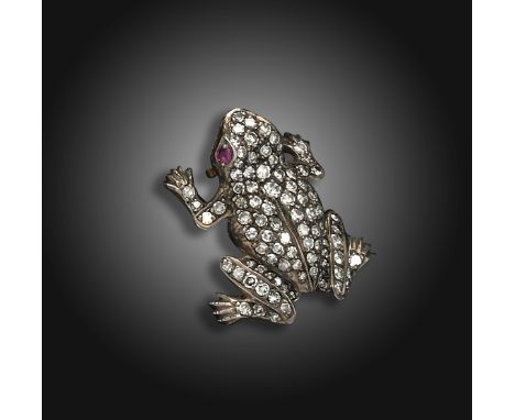 An early 20th century diamond-set frog brooch, pavй-set overall with graduated circular-cut diamonds in silver and gold, ruby