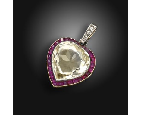 An early 20th century ruby and diamond-set heart pendant, centred with a heart-shaped diamond weighing approximately 3.00cts,