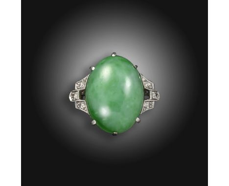 A jade and diamond ring, the green jadeite jade cabochon is set with single-cut diamonds to the shoulders in white gold, size