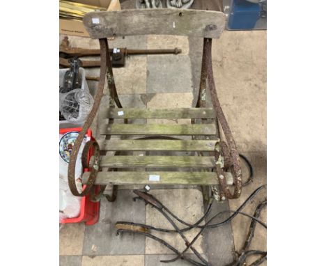 A Victorian wrought iron garden chair and a pair of bench ends 