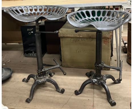 Two cast metal tractor stools 