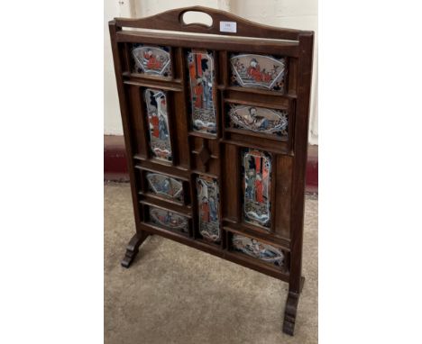 A Chinese elm fire screen with hand painted glass Chinoiserie panels 