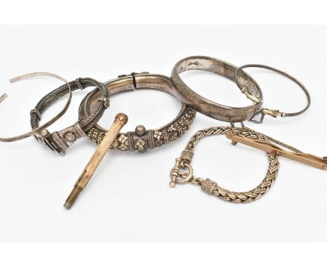 A BAG OF WHITE METAL BANGLES AND BRACELETS, to include a silver hinged bangle, hallmarked Chester, fitted with a push piece i