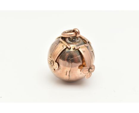 A MASONIC ORB PENDANT, rose metal exterior opens to reveal a white metal interior with engraved symbols, yellow metal fitting