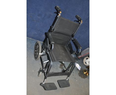 A KARMA MOBILITY FOLDING WHEELCHAIR, with two footrests