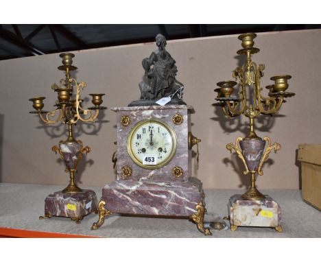 A VINTAGE FRENCH MARBLE MANTEL CLOCK AND CANDLELABRA GARNITURES, a rose and ivory colour marble, cast metal figure and painte