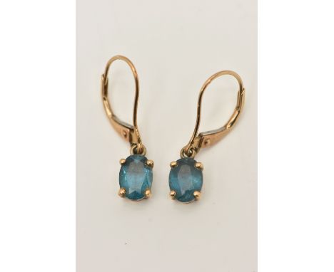 A PAIR OF YELLOW METAL BLUE TOPAZ DROP EARRINGS, each set with an oval cut blue topaz in claw settings, stamped 375, to the f