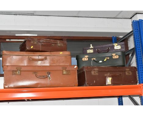 A COLLECTION OF VINTAGE LUGGAGE, comprising four assorted size brown early twentieth century suitcases, a small dark green fa