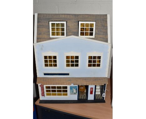 A MODERN WOODEN DOLLS HOUSE, scratch or kit built, front opens to reveal self-contained ground floor room used as a shop, tog
