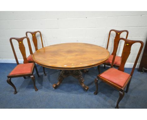 A VICTORIAN WALNUT OVAL TILT TOP LOO TABLE, raised on four turned supports, the four legs with foliate details, and ceramic c