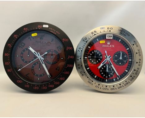 A ROLEX DEALERS DISPLAY OYSTER COSMOGRAPH ADVERTISING WALL CLOCK, with a red dial, diameter 34cm, along with an oyster perpet