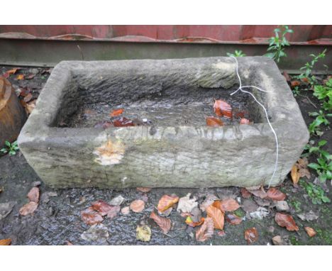 A RECTANGULAR WEATHERED COMPOSITE TROUGH, width 77cm x depth 40cm x height 24cm (condition report: general signs of weatherin