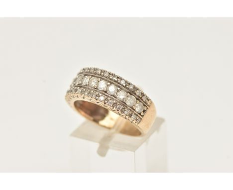 A 9CT GOLD DIAMOND RING, set with three rows of round brilliant cut diamonds, leading onto a polished band, estimated total d