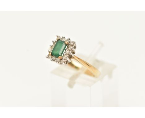 A 9CT GOLD EMERALD AND DIAMOND CLUSTER RING, set with an emerald within a four claw setting and a surround of small brilliant