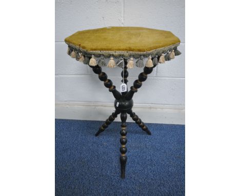 A 19TH CENTURY EBONISED AND PARCEL GILT GYPSY TABLE, with an upholstered octagonal surface, raised on bobbin turned supports 