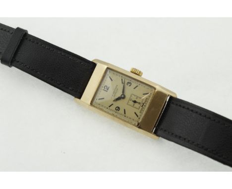 A 1950's 9ct J W BENSON gents wristwatch, H/M Birmingham 1950, working manual-wind 15 jewel movement, later black leather str