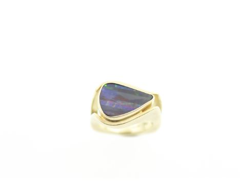 A modern 'Queensland boulder opal' single stone ring with multi-coloured striations, the heavy 1970's style mount marked 18ct