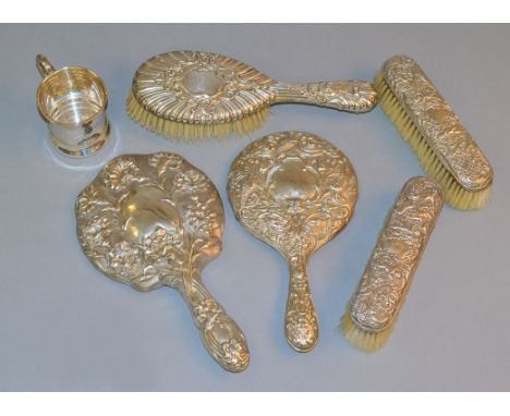 Five pieces of silver backed dressing table ware, various H/M, together with a christening mug marked sterling (6)