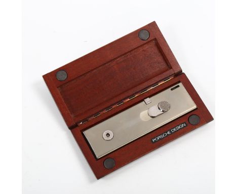 A PORSCHE DESIGN lighter in original wooden caseNeeds filling but appears to be in working order, hinge loose on box. 