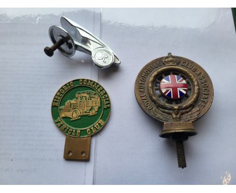 A Royal Automobile Club Associate car badge, a Historic Commercial Vehicle Club badge, an Art Deco radiator mascot with "R" d