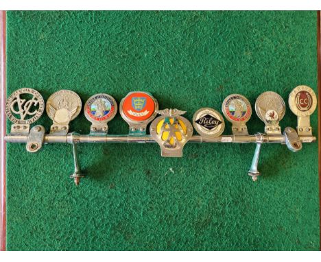 Desmo badge bar with nine various badges (AA, St Christopher, Caravan Club, VCC, Riley Club, Hull, etc) Art Deco and Eagle ca