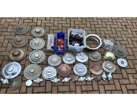 Hubcaps, including Alvis and Jaguar, plus several "Knock on" spinners. A set of beauty rings. a set of Ford (possibly early T