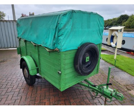 A vintage car trailer, steel chassis, wooden plank construction, hinged drop down rear ramp, tarpaulin cover. Approximate out