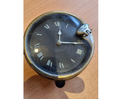 Watford Car Clock, by North and Sons. Black face, front key wind, with securing ring and collar. (1 item)