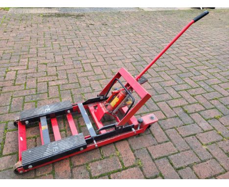 A portable hydraulic motorcycle lift. (1 item)