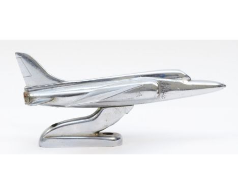 A chrome desk mounted model of a Folland Gnat, stamped to the underside, 'Made by S.E. Kimm, Folland Gnat, 1964', 17.5cm. (1 