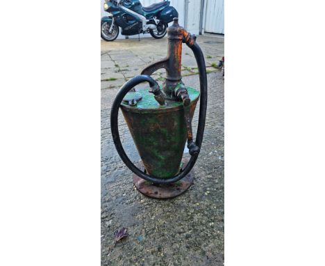 A green painted hand cranked oil dispenser. (1 item)