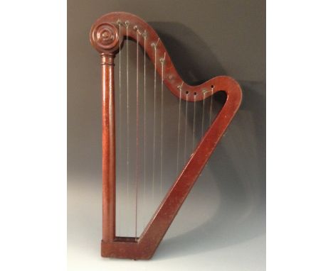 A 19th century mahogany lyre or harp, serpentine cresting applied with draught turned roundels, turned column, steel tuning p