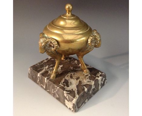 A Neo-Classical style desk weight, cast as a tripod urn, ram mask monopodia, marble base, 11cm wide, early 20th century