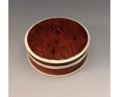 A George III ivory mounted yew circular snuff box, push-fitting cover, 8cm diam, c.1820
