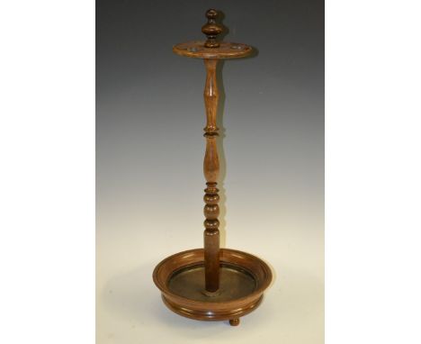 A 19th century mahogany church warden pipe stand, turned baluster finial above a circular rest with three apertures, turned d