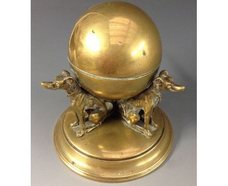 A 19th century French brass inkwell, domed spherical cover and reserved resting on the backs of three whippets, circular base