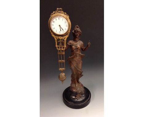 An early 20th century spelter 'Diana' mystery timepiece, she stands, holding combined movement and pendulum aloft in her righ