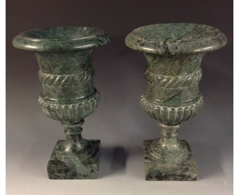 A pair of green marble half-fluted campana pedestal mantel urns, rope-twist girdles, disc socles, square bases, 30cm high, 20