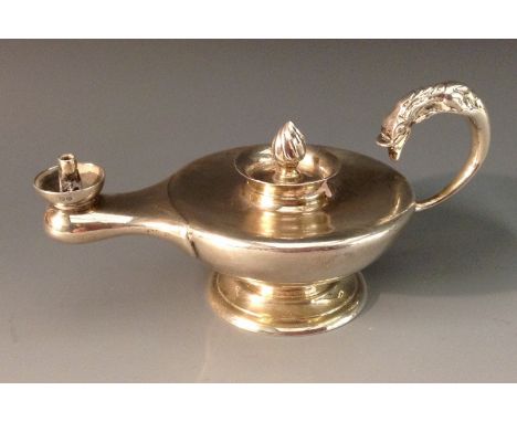 A George V silver novelty table cigar lighter, as a Roman lamp, flame finial, flying-scroll dolphin handle, 13cm long, J B Ch