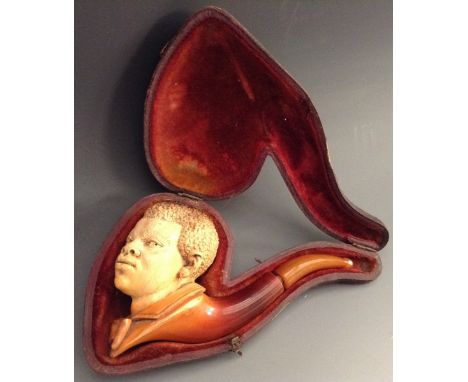 A 19th century Meerschaum novelty pipe, the bowl carved as the head of a negro boy, 12cm long, leather case, c. 1880