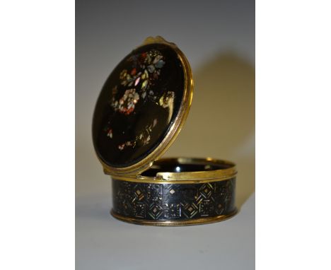 An early 19th century lacquered papier mache circular table snuff box, hinged cover painted and inlaid in abalone shell with 