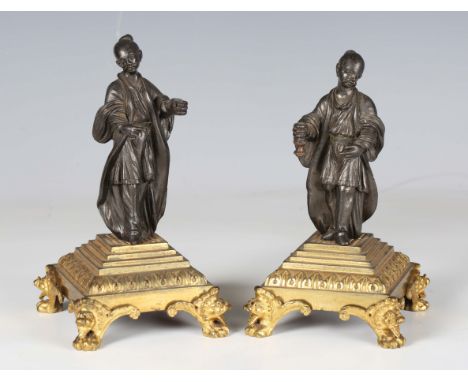 A pair of 19th century brown patinated and gilt bronze chinoiserie figures, each standing male raised on a finely cast gilt b