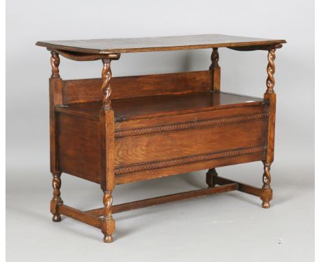 A George V oak monk's bench with hinged top and box seat, height 70cm, width 91cm, depth 44cm.Buyer’s Premium 29.4% (includin
