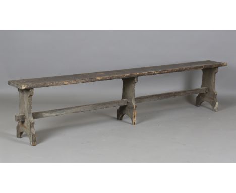A late 19th century painted pine bench, raised on three shaped supports, height 46cm, length 218cm, depth 24cm.Buyer’s Premiu