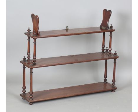 A mid-Victorian mahogany three-tier graduated wall shelf, the top fitted with a pair of hinged bookends, height 68cm, width 8