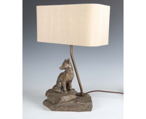 A modern David Hunt bronzed resin table lamp, the support modelled as a fox seated on a rocky outcrop, fitted with a taupe si