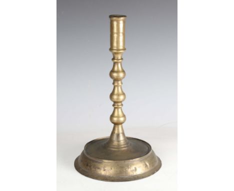 An Ottoman turned bronze alloy candlestick of large proportions, raised on a wide circular foot, height 40cm.Buyer’s Premium 