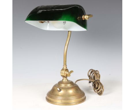 A mid-20th century brass and green glass adjustable desk lamp, height 40cm.Buyer’s Premium 29.4% (including VAT @ 20%) of the