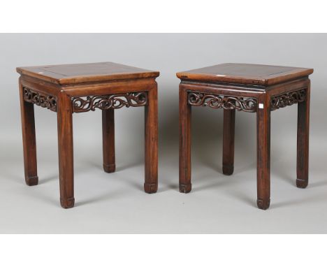 A pair of 19th century Chinese hardwood lamp tables, the square tops above pierced friezes and block legs, height 51cm, width